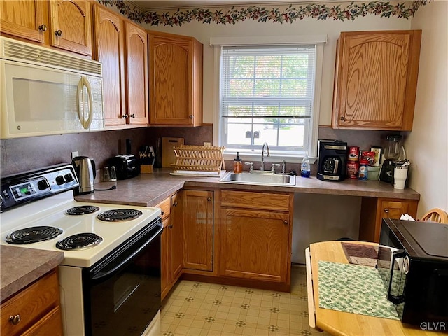 kitchen featuring white appliances and sink