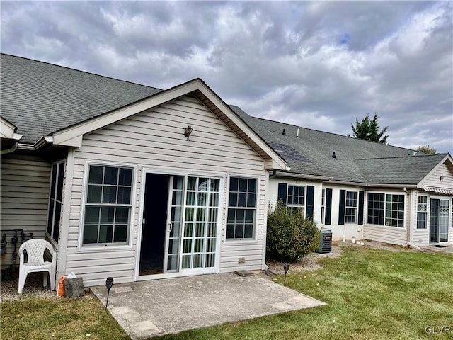 rear view of house with a yard, a patio area, and cooling unit