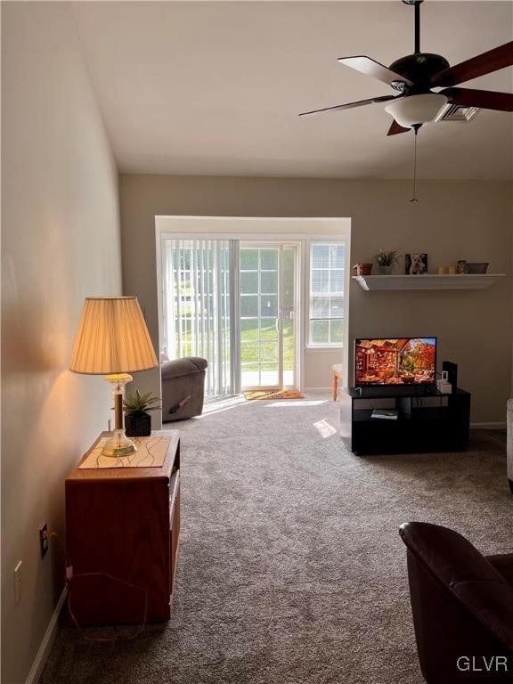 carpeted living room featuring ceiling fan