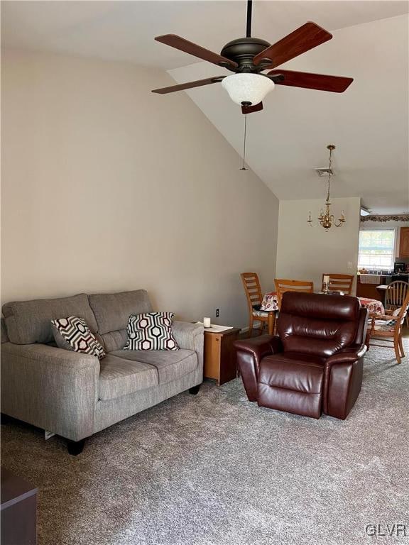 living room with lofted ceiling, carpet, and ceiling fan with notable chandelier