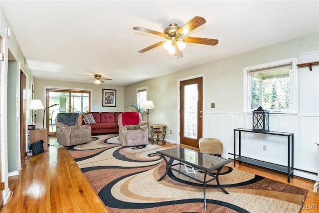 living room featuring ceiling fan, a healthy amount of sunlight, and hardwood / wood-style flooring