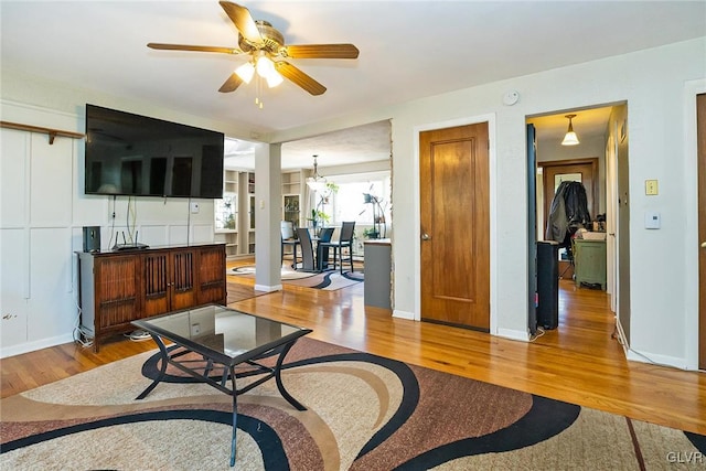 living room with ceiling fan and hardwood / wood-style floors