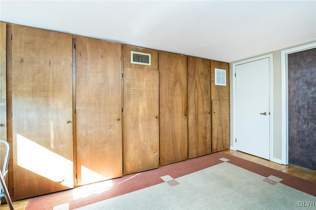 unfurnished bedroom with light carpet and a closet