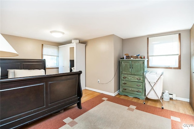 bedroom featuring light hardwood / wood-style floors and baseboard heating