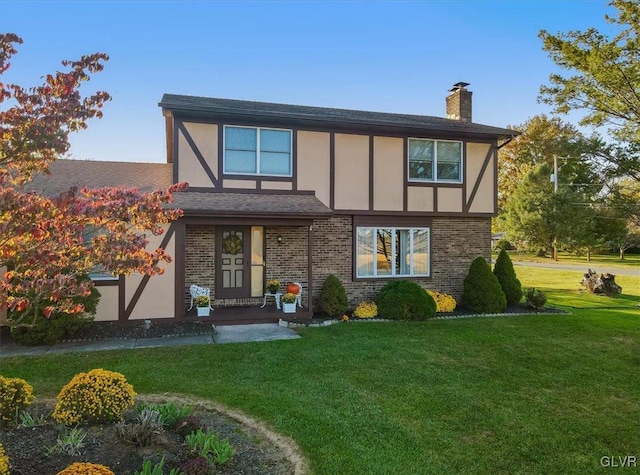 tudor home featuring a front lawn