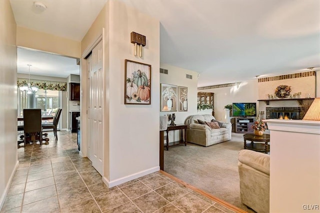 living room featuring carpet and a notable chandelier