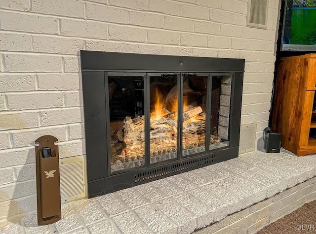 interior details featuring a brick fireplace