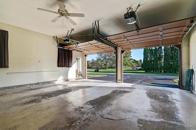 garage with a garage door opener and ceiling fan