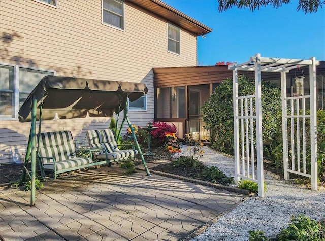 view of patio featuring a sunroom and a pergola