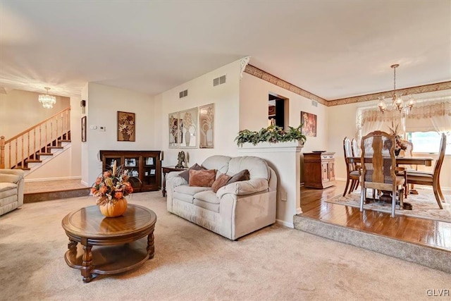 living room with wood-type flooring and an inviting chandelier