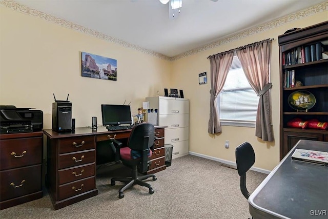 carpeted office space featuring ceiling fan