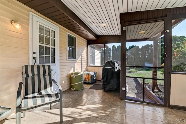 sunroom / solarium featuring wood ceiling