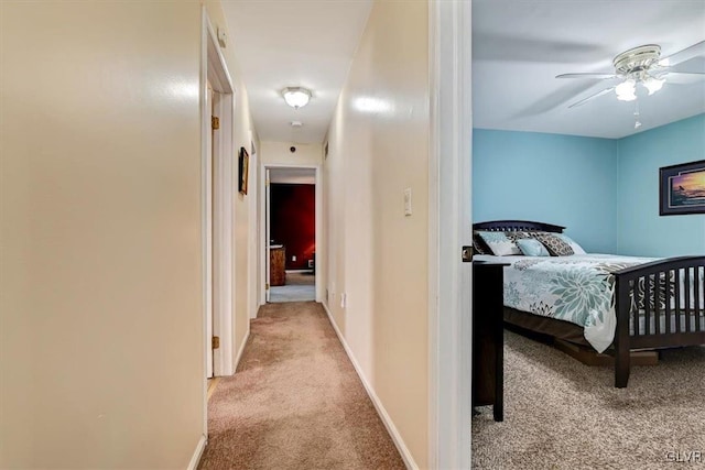 bedroom featuring ceiling fan and light carpet