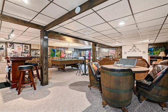 carpeted dining space featuring wooden walls, a paneled ceiling, billiards, and indoor bar