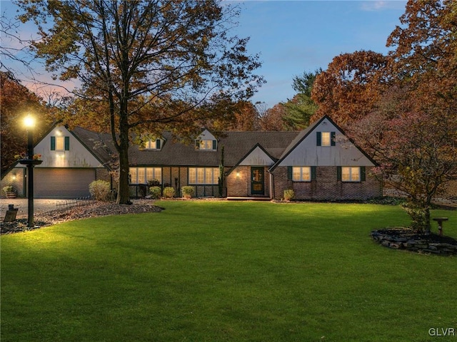 view of front of house with a yard and a garage