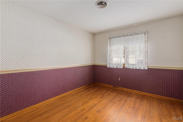 empty room with hardwood / wood-style flooring