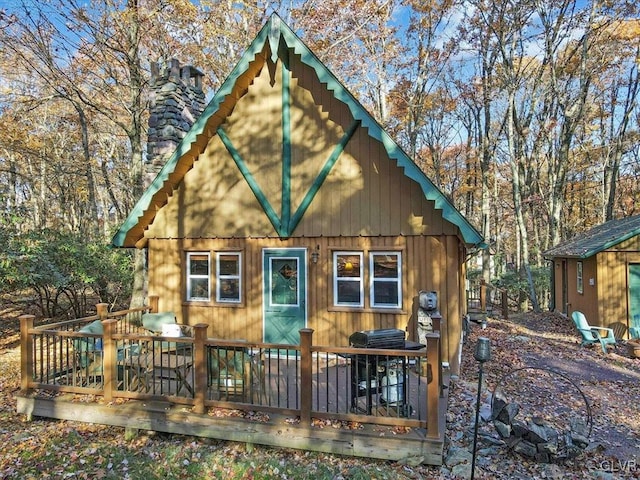 rear view of house featuring a wooden deck