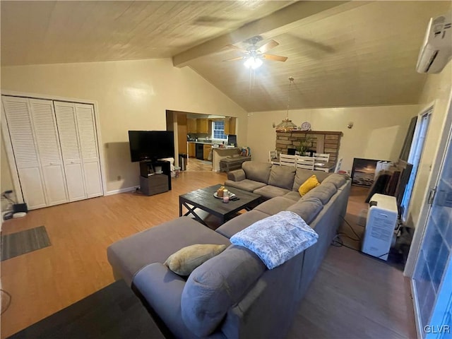 living room with vaulted ceiling with beams, a wall unit AC, hardwood / wood-style flooring, and ceiling fan