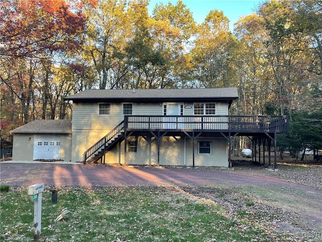 view of front of property featuring a wooden deck and a garage