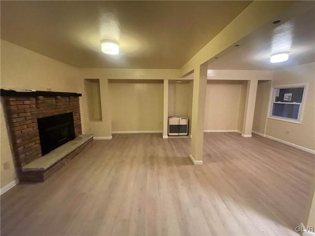 basement featuring heating unit and light wood-type flooring