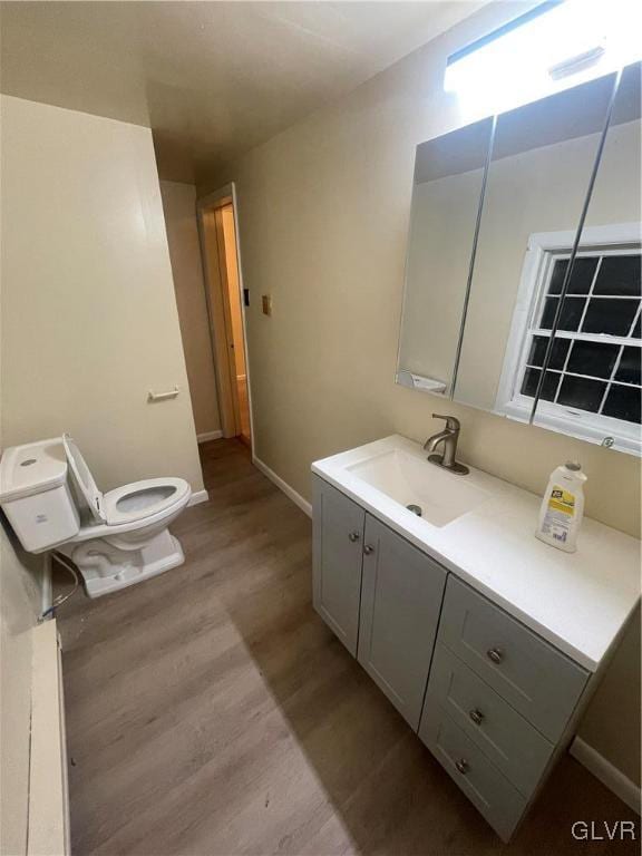 bathroom with vanity, hardwood / wood-style floors, and toilet