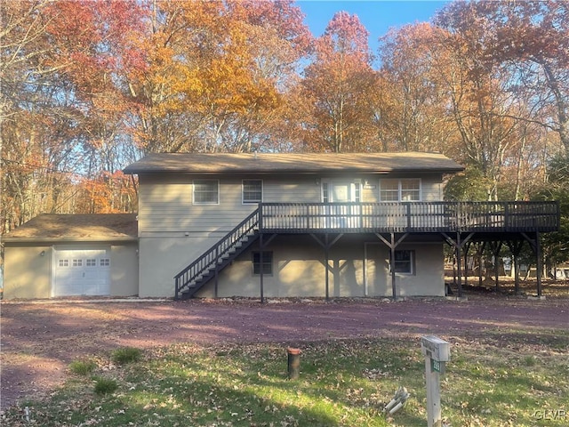 view of front of home featuring a deck and a garage