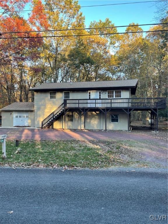 view of front of home with a deck and a garage