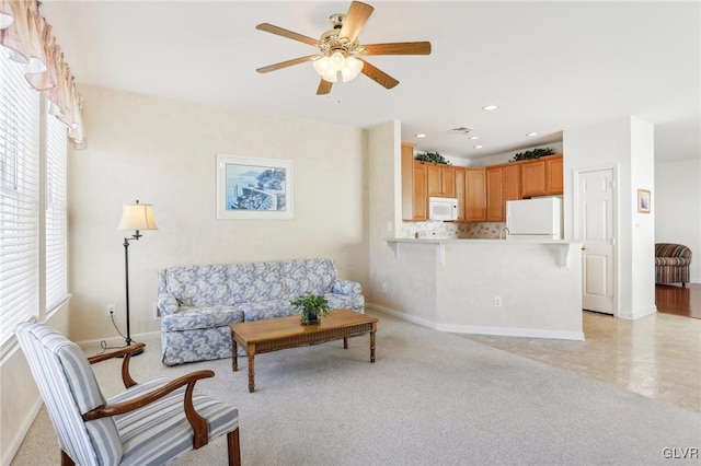 living room featuring light carpet, ceiling fan, and plenty of natural light