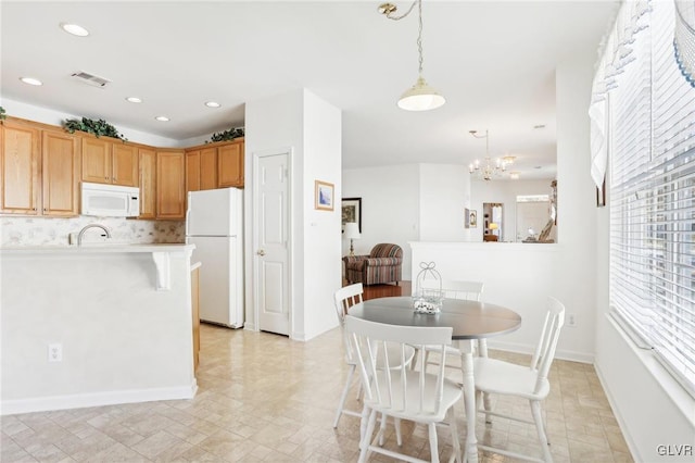 dining room featuring an inviting chandelier and sink