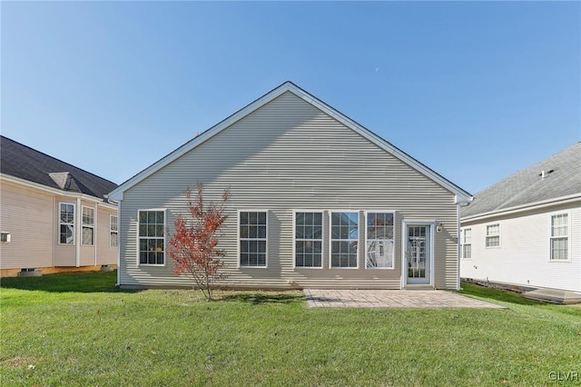 back of house with a lawn and a patio