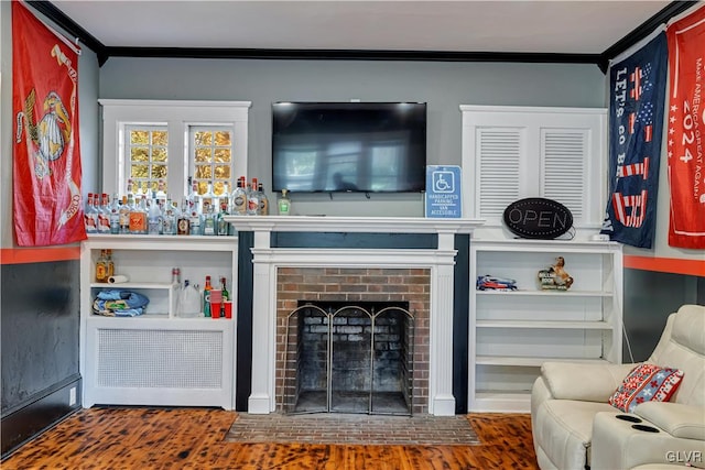 living room featuring dark hardwood / wood-style flooring, ornamental molding, radiator heating unit, and a brick fireplace