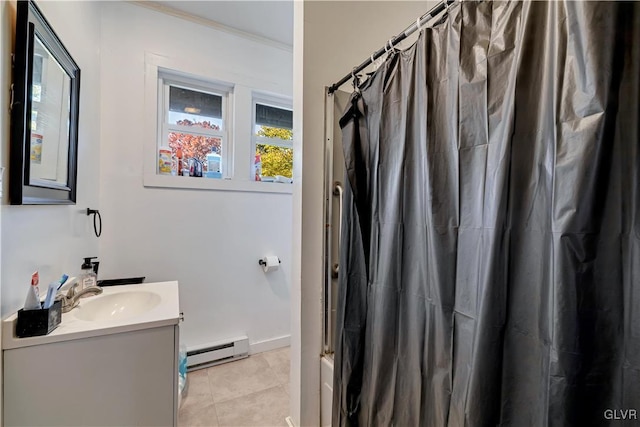 bathroom with vanity, ornamental molding, baseboard heating, and tile patterned floors