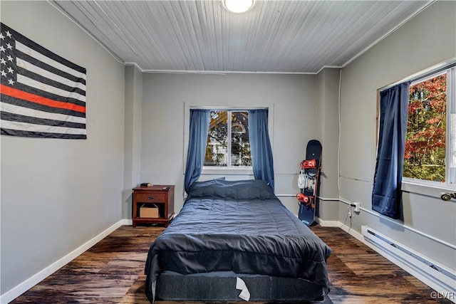 bedroom featuring wood ceiling, ornamental molding, a baseboard heating unit, and dark hardwood / wood-style flooring