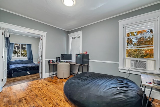 bedroom featuring crown molding, cooling unit, and hardwood / wood-style flooring