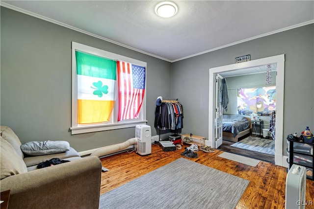 sitting room featuring crown molding and hardwood / wood-style flooring