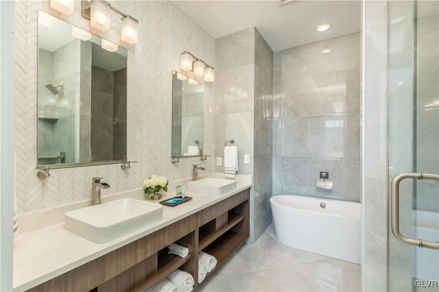 bathroom featuring tile walls, vanity, and independent shower and bath