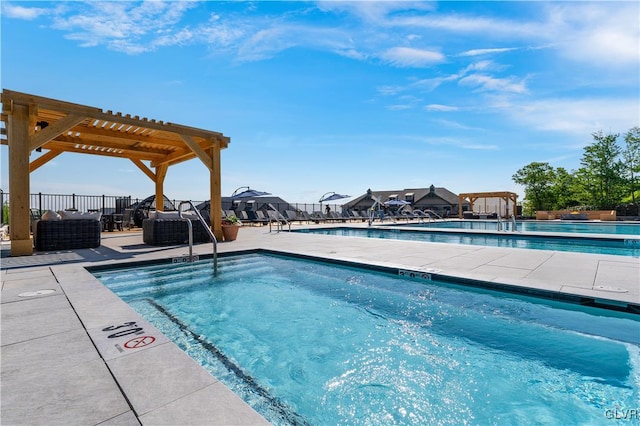 view of swimming pool featuring a patio area and a pergola