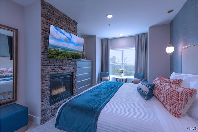 carpeted bedroom featuring a fireplace