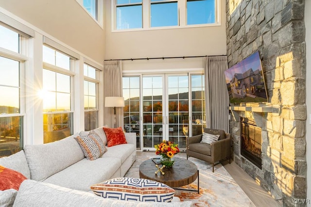 sunroom / solarium featuring a stone fireplace and a wealth of natural light