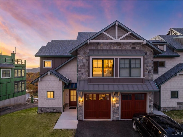 craftsman-style home featuring a lawn and a garage