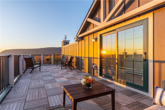 deck at dusk featuring baseboard heating