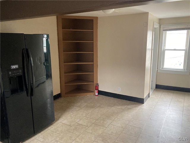 interior space featuring black refrigerator with ice dispenser