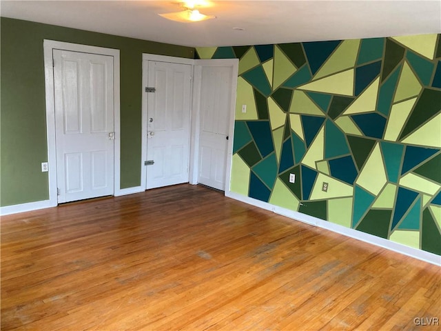 spare room with hardwood / wood-style floors