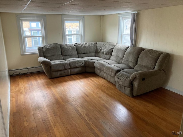 living room with light hardwood / wood-style flooring and a baseboard radiator