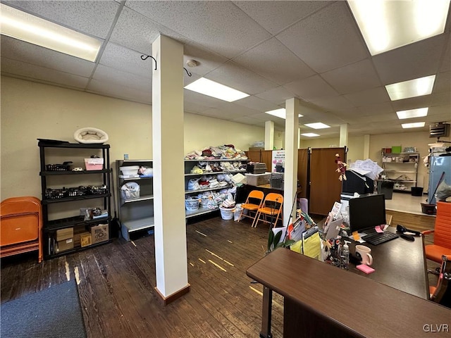 office area with dark hardwood / wood-style flooring and a drop ceiling