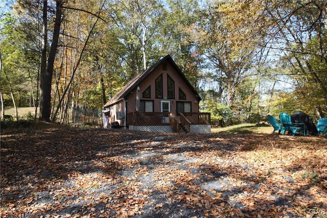 view of side of property featuring a wooden deck