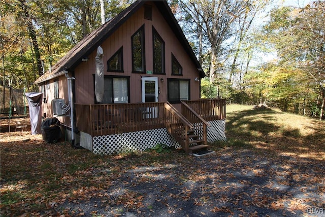 back of house with a deck