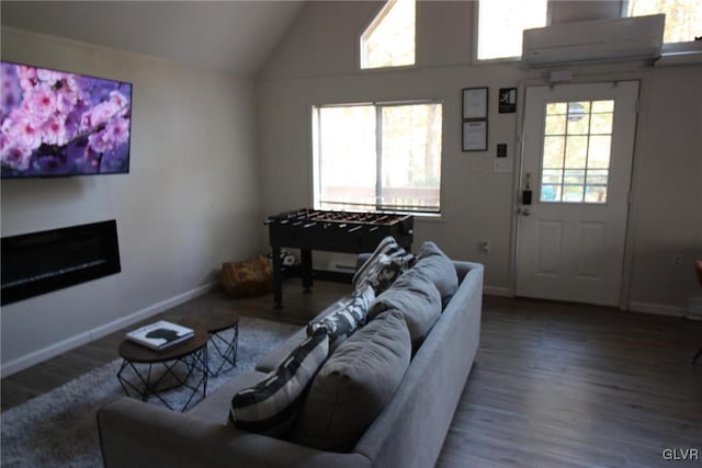 living room with a wall unit AC, lofted ceiling, and hardwood / wood-style floors