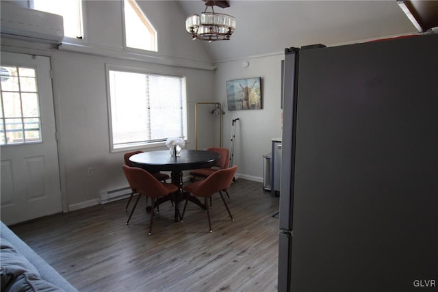 dining area with a baseboard radiator, light hardwood / wood-style floors, and plenty of natural light