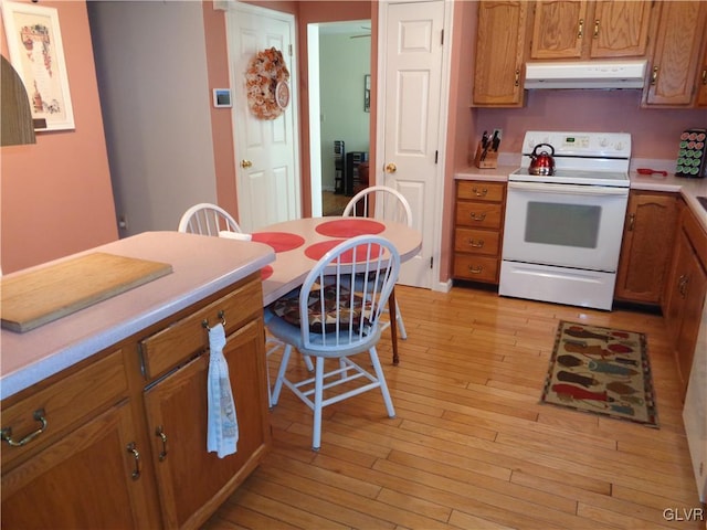 kitchen featuring white electric range and light hardwood / wood-style floors